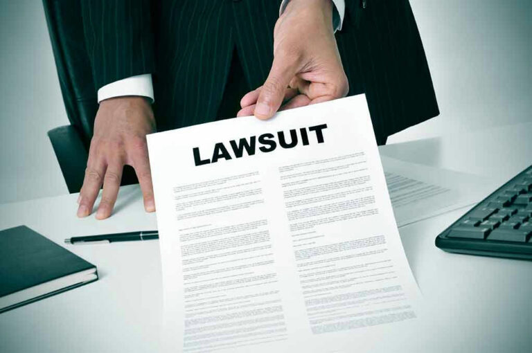 Holding a document titled Lawsuit in an office.