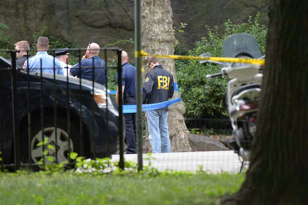 FBI agents and police officers at a crime scene.