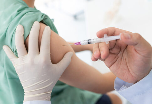 A healthcare professional administering a vaccine to a patients arm