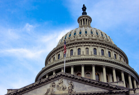 View of the U.S. Capitol building dome against a blue sky