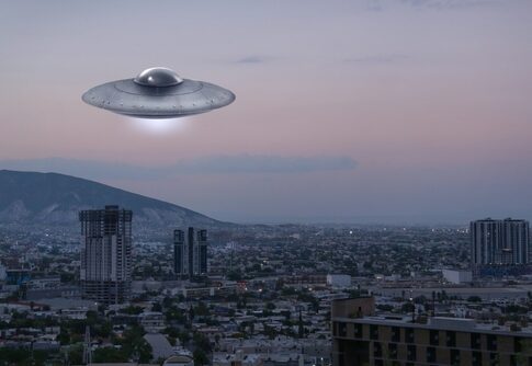 A UFO hovering over a city skyline during twilight