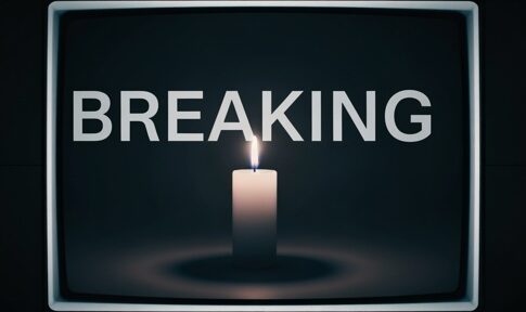 A candle illuminated against a dark background with the word 'BREAKING' displayed above it